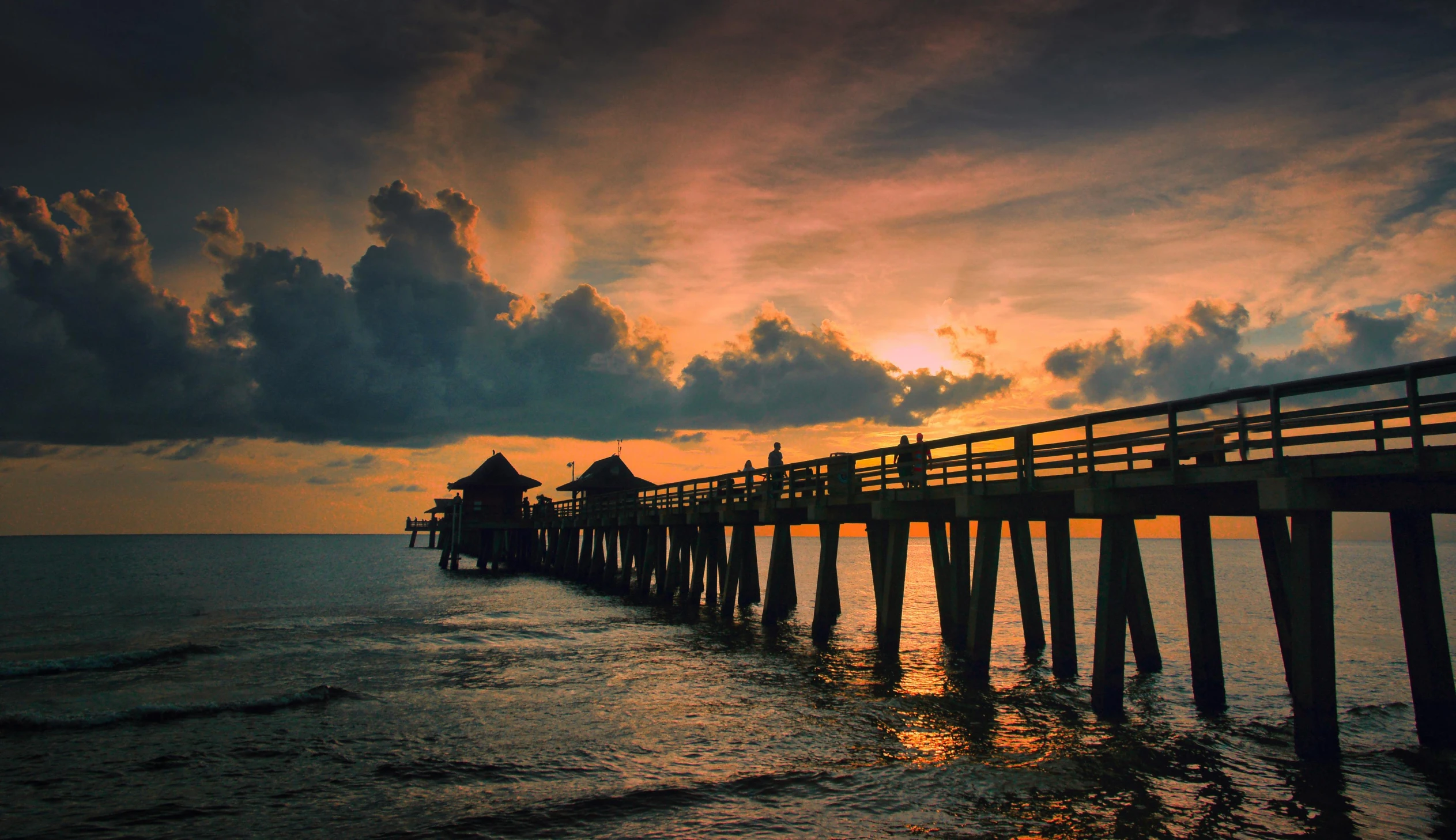 a pier stretches out into the ocean at sunset, by Josh Bayer, pexels contest winner, renaissance, naples, 2 5 6 x 2 5 6 pixels, photo of the middle of the ocean, slide show