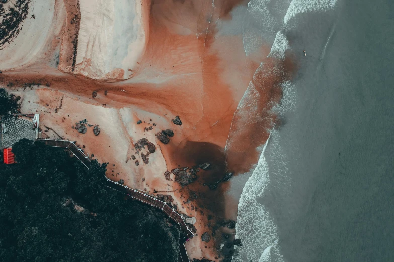 a large body of water next to a sandy beach, by Daniel Lieske, pexels contest winner, generative art, satelite imagery, dark grey and orange colours, blood on sand, south african coast