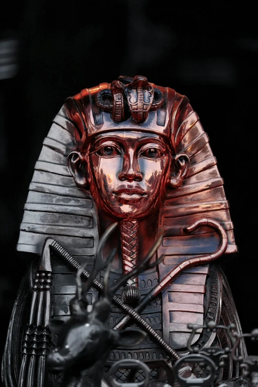 a close up of a statue of a pharaoh, by Kev Walker, silver gold red details, weta digital, 1980s metal artwork, kris kuksi