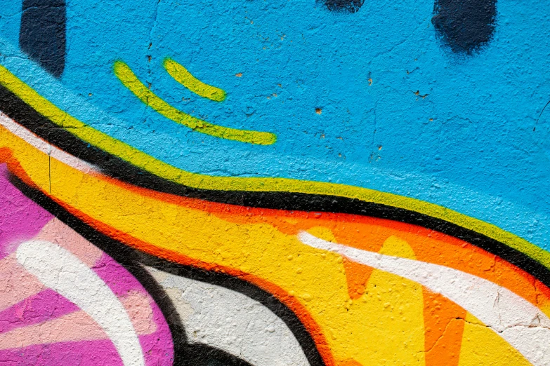 a yellow fire hydrant sitting in front of a colorful wall, graffiti art, by Niko Henrichon, trending on unsplash, graffiti, zoomed in, 144x144 canvas, strong blue and orange colors, zoomed in shots