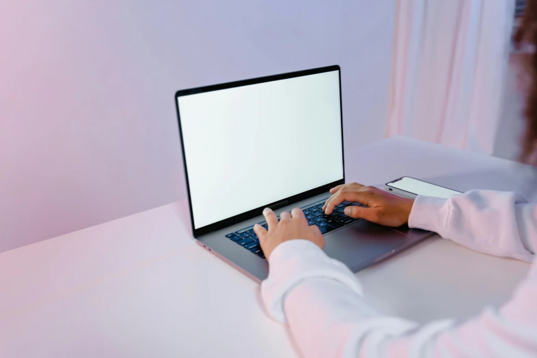 a woman is typing on a laptop computer, a computer rendering, pexels, gradient brown to white, subtle neon underlighting, non-binary, in a white room