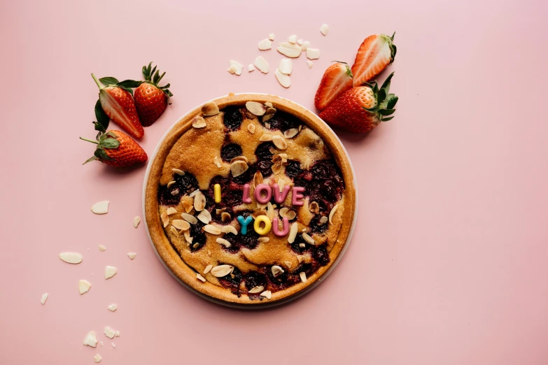 a cookie with the word love spelled on it surrounded by strawberries, by Julia Pishtar, trending on pexels, pizza pie, 🎀 🧟 🍓 🧚, i love you, brown and pink color scheme