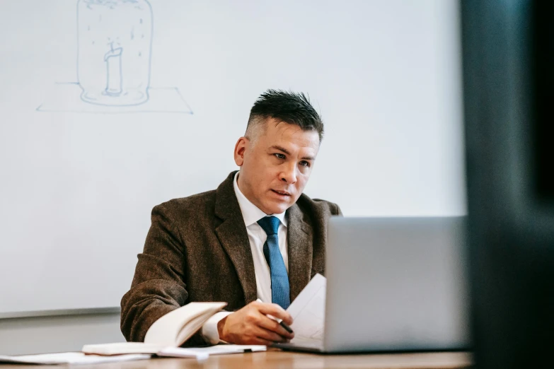 a man sitting in front of a laptop computer, a picture, in a classroom, profile image, thumbnail, lawyer