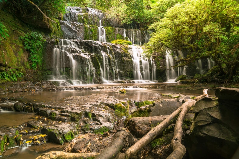 a waterfall in the middle of a forest, by Julian Allen, unsplash, hurufiyya, tree ferns, several waterfalls, 2000s photo, high quality product image”