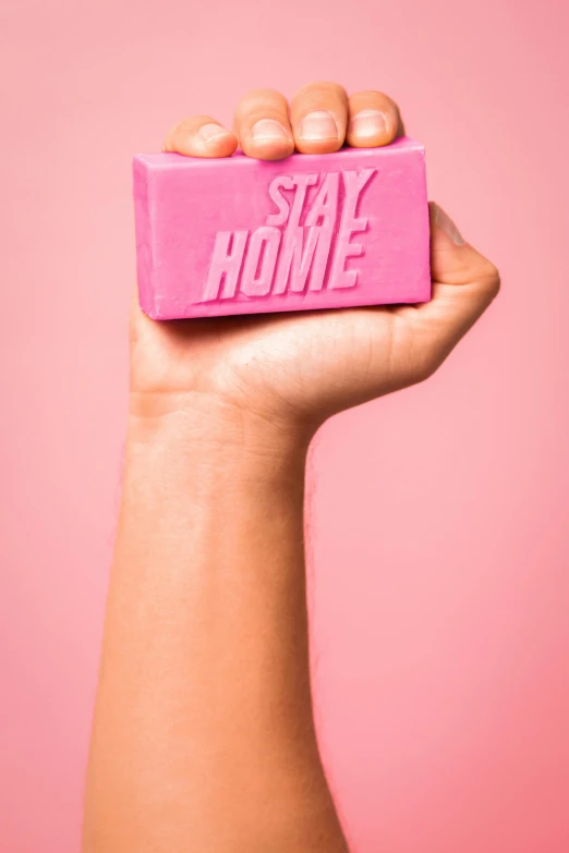 a hand holding a pink block that says stay home, carved soap, thumbnail, raphael personnaz, skincare