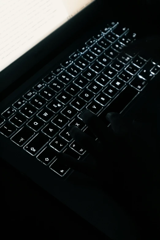 a laptop computer sitting on top of a desk, by Sam Black, pexels, vantablack chiaroscuro, small neon keyboard, black and silver, my computer icon