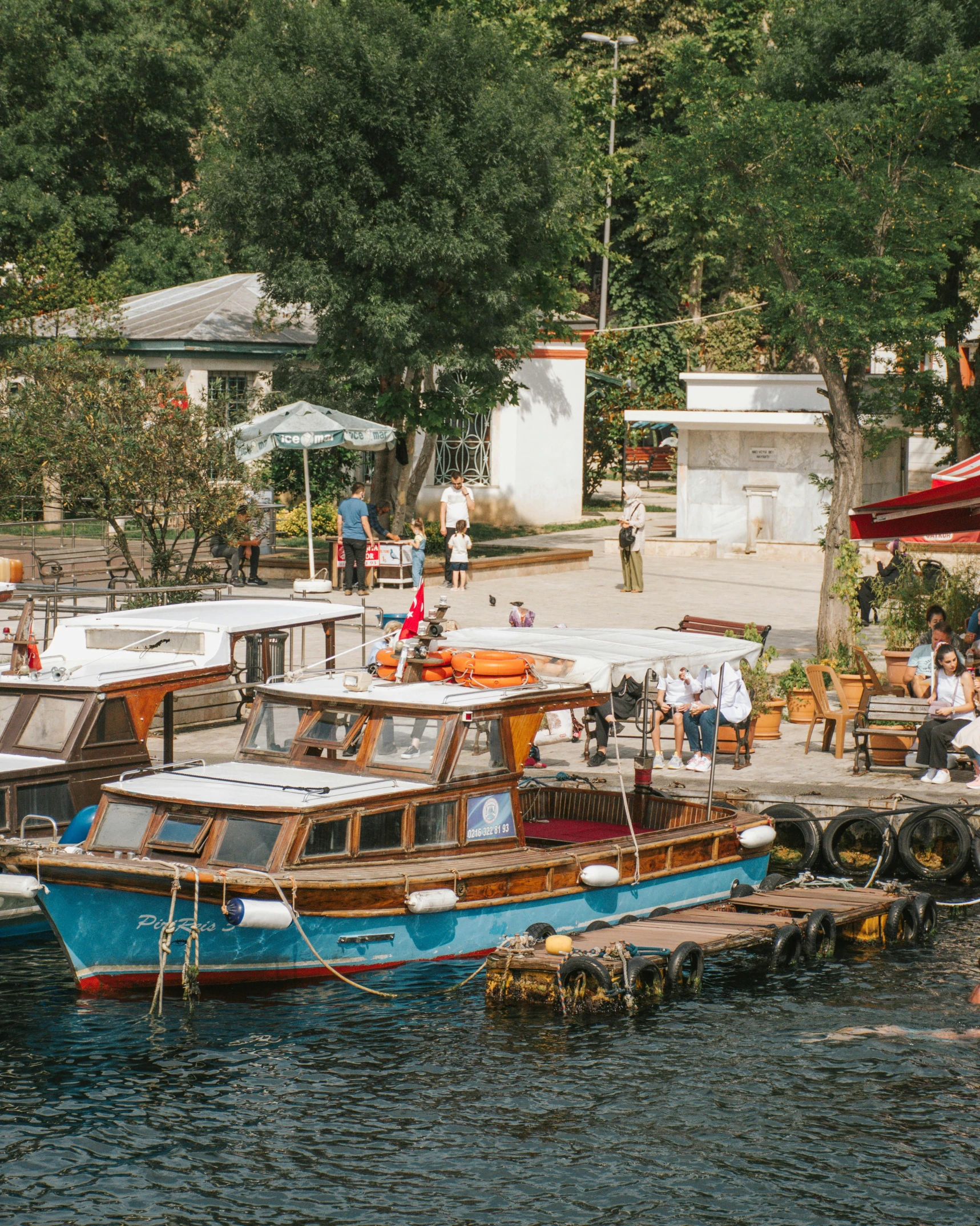 a group of boats sitting on top of a body of water, kreuzberg, lush surroundings, al fresco, vintage vibe