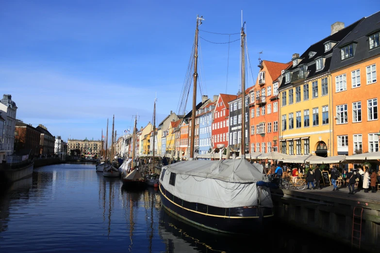 a number of boats in a body of water near buildings, by Jesper Knudsen, pexels contest winner, hurufiyya, square, coloured photo, fan favorite, björk