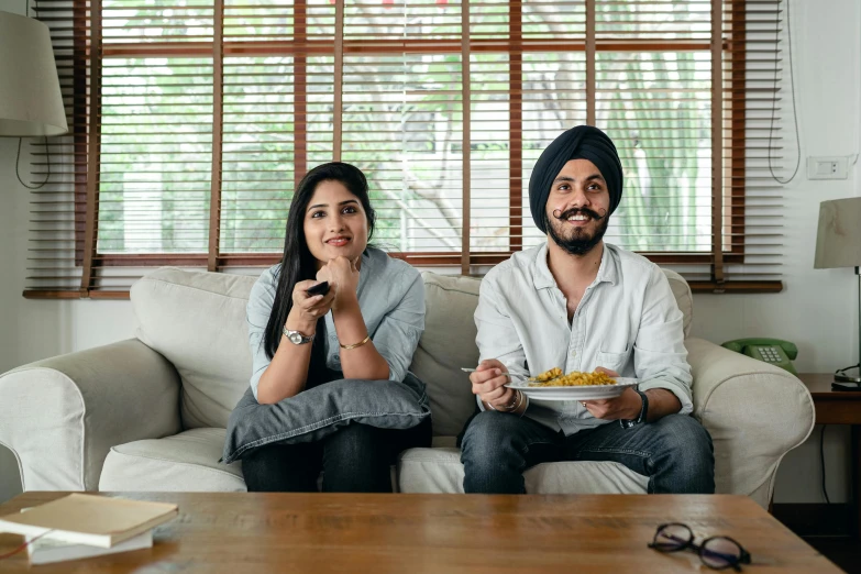 a man and a woman sitting on a couch eating food, inspired by Manjit Bawa, pexels, serial art, watching tv, square, switch, high quality upload