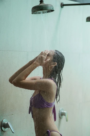 a woman in a purple bikini standing in a shower, pexels contest winner, rain and thick strands of mucus, teenage girl, sri lanka, rain sensor
