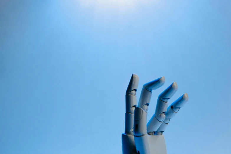 a robotic hand reaching up into the sky, by Julian Allen, relaxed. blue background, photographed for reuters, grey, small robots