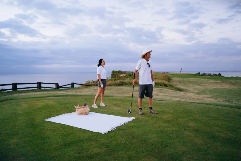 a man and a woman playing a game of golf, unsplash, happening, views to the ocean, helipad, linen, lee madgwick & yuto yamada