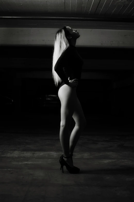 a black and white photo of a woman in high heels, a black and white photo, unsplash, renaissance, white haired, wearing a black bodysuit, (night), derriere