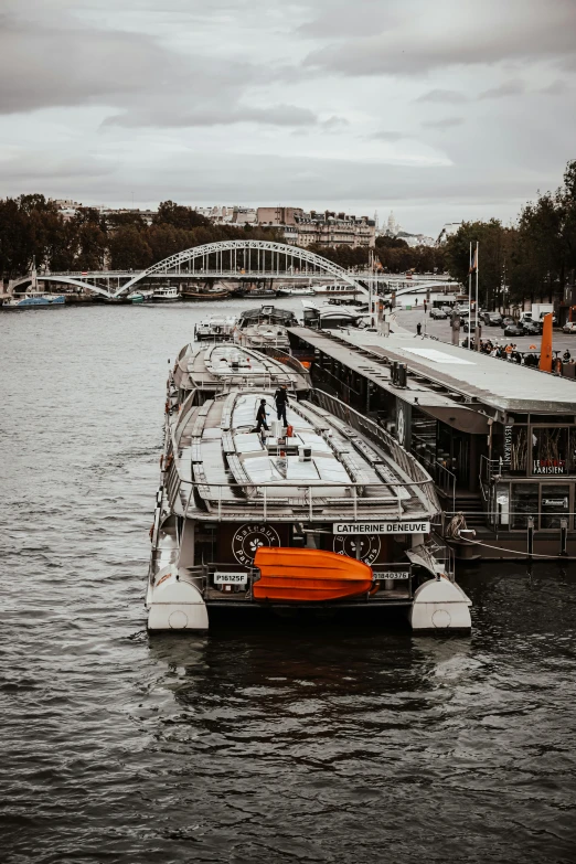 a boat that is sitting in the water, in paris, orange grey white, boat dock, thumbnail