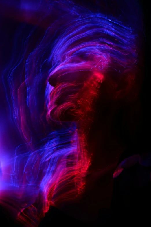 a blurry image of a woman with long hair, pexels contest winner, light and space, red and blue black light, abstract purple lighting, abstracted, electric swirls