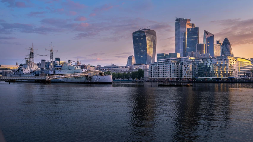 a large body of water with a city in the background, a picture, by Jay Hambidge, pexels contest winner, london south bank, magic hour, slide show, norman foster