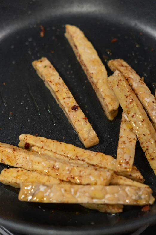 a pan filled with fries sitting on top of a stove, jackstraws, thumbnail, frontal shot, slate