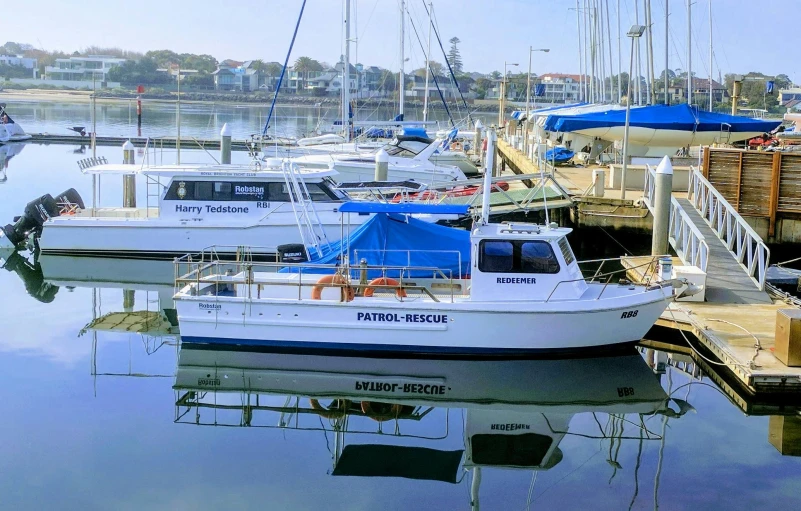 a number of boats in a body of water, harbour in background, profile pic, local heroes, vista view