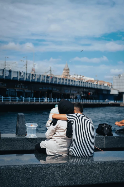 two people sitting on a bench next to a body of water, by irakli nadar, harbour in background, hugging, having a snack, on a canva