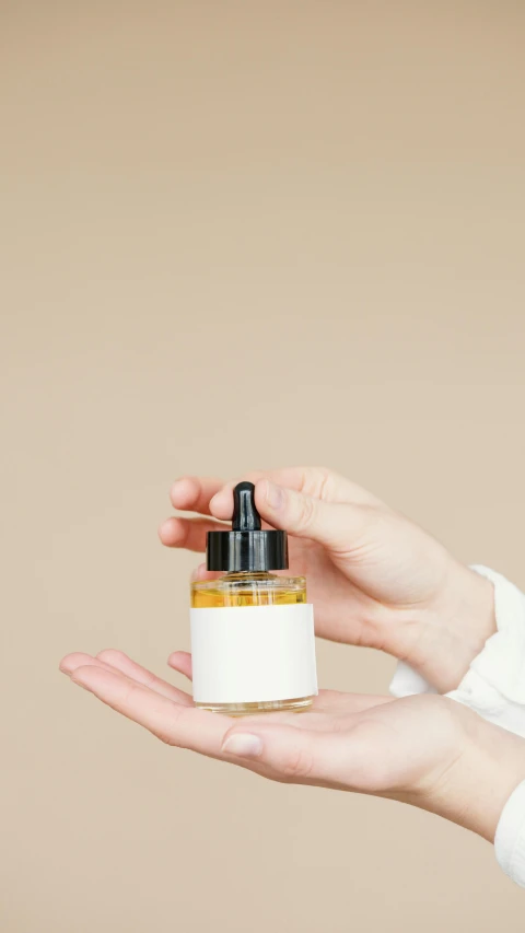 a woman holding a bottle of oil in her hand, minimalism, thumbnail, apothecary, on a canva, low quality photo