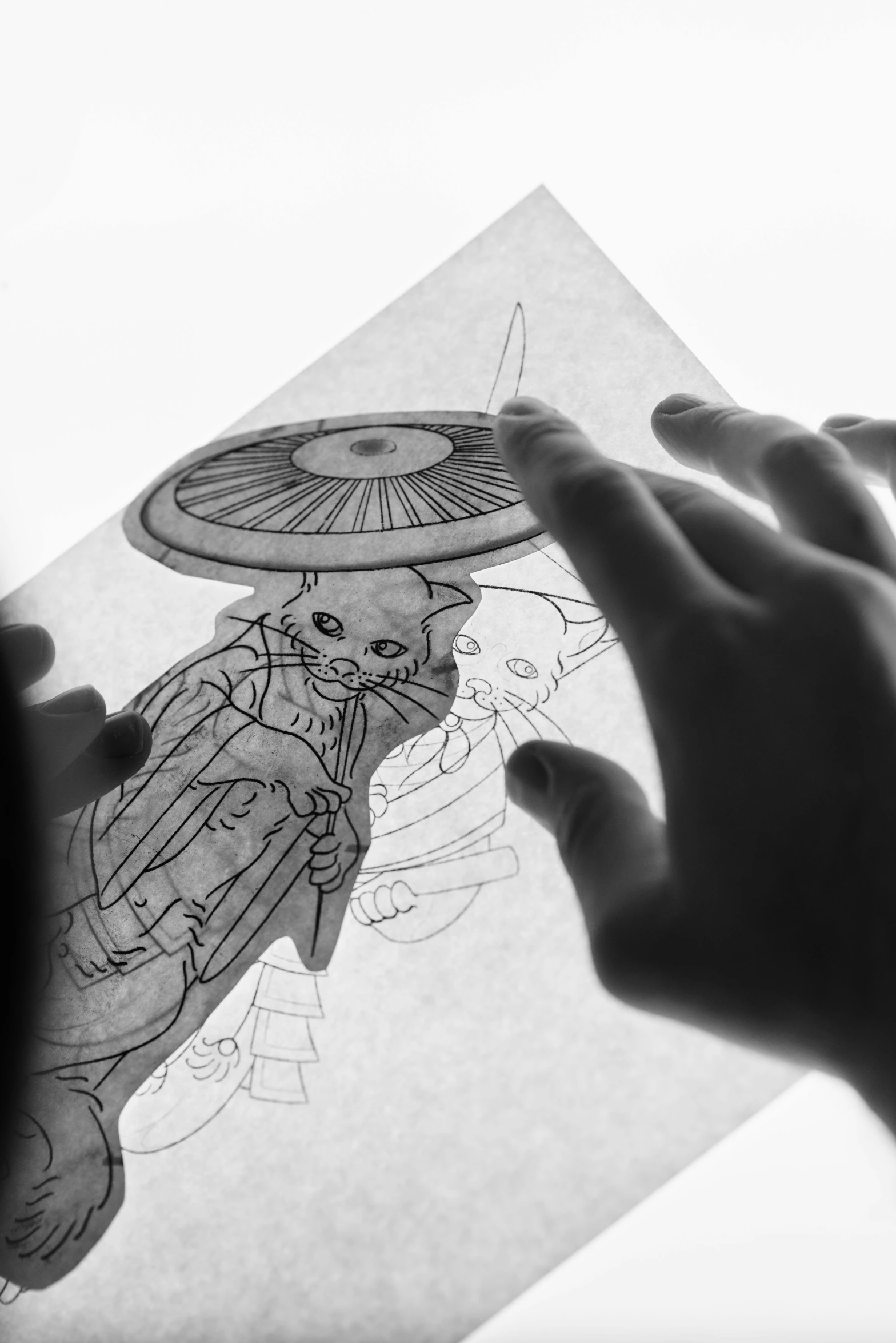 a person holding a piece of paper with a drawing on it, a detailed drawing, inspired by Kanō Naizen, light tracing, children's illustration, coherent hands, behind the scenes