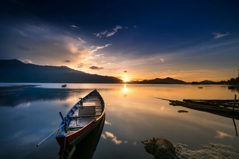 a boat sitting on top of a body of water, pexels contest winner, sumatraism, colours of the sunset, multiple stories, blissful landscape, stunning screensaver