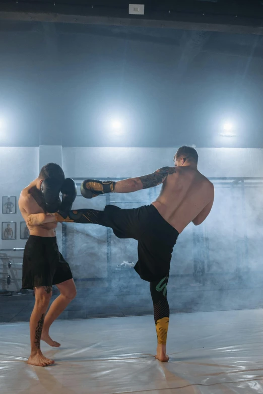 a couple of men standing on top of a cement floor, kickboxing, strong lights, point break, compression