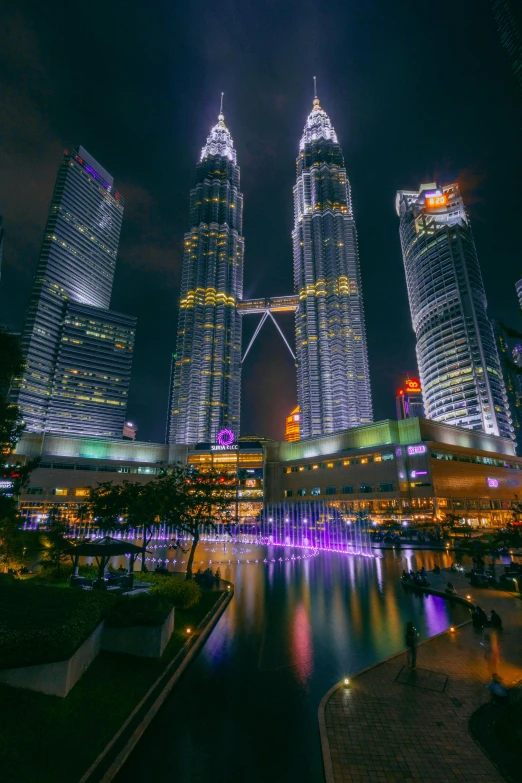 the city skyline is lit up at night, by Bernardino Mei, pexels contest winner, hurufiyya, twin towers, square, 4k image, f / 1