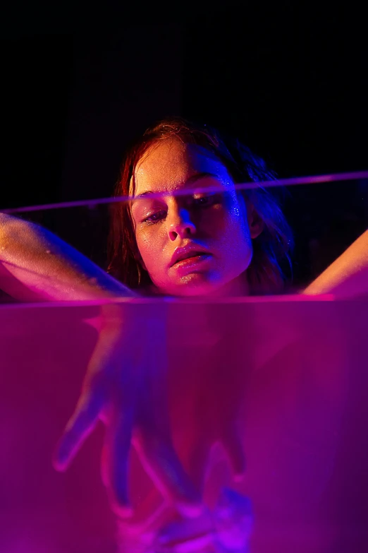 a close up of a person in a bath tub, inspired by Nan Goldin, holography, kaya scodelario, purple scene lighting, with screens and silks, vivid studio light