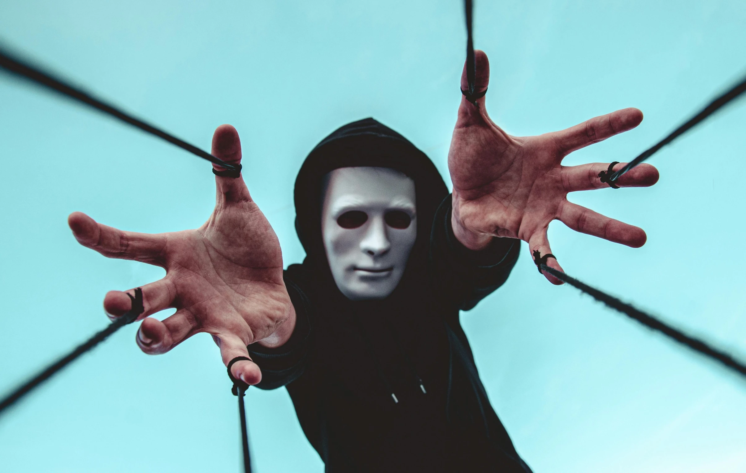 a man that is standing up with his hands in the air, a statue, pexels contest winner, surrealism, michael myers mask, avatar image, hanging from white web, wearing a black hoodie