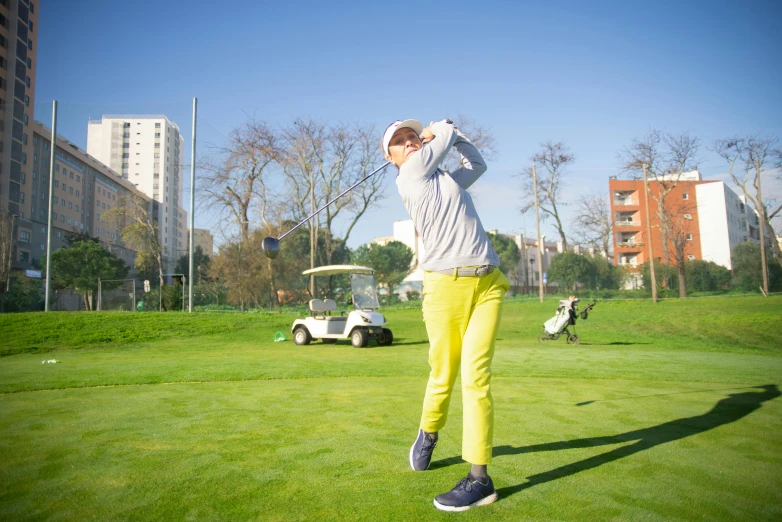 a man swinging a golf club at a golf course, by Mathias Kollros, pexels contest winner, figuration libre, city park, avatar image, estefania villegas burgos, a blond