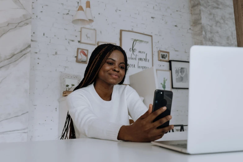 a woman sitting at a table using a cell phone, a picture, trending on pexels, happening, with brown skin, sitting in front of computer, selfie photo, cute photo