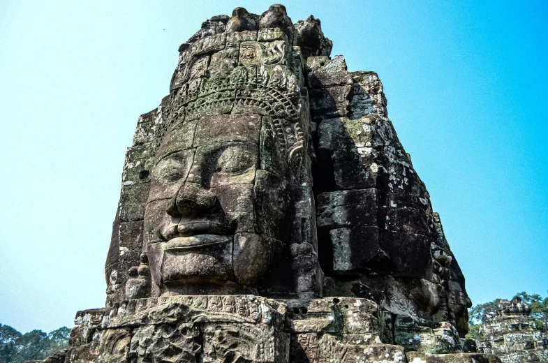 a large stone face carved into the side of a building, a statue, pexels contest winner, angkor thon, avatar image