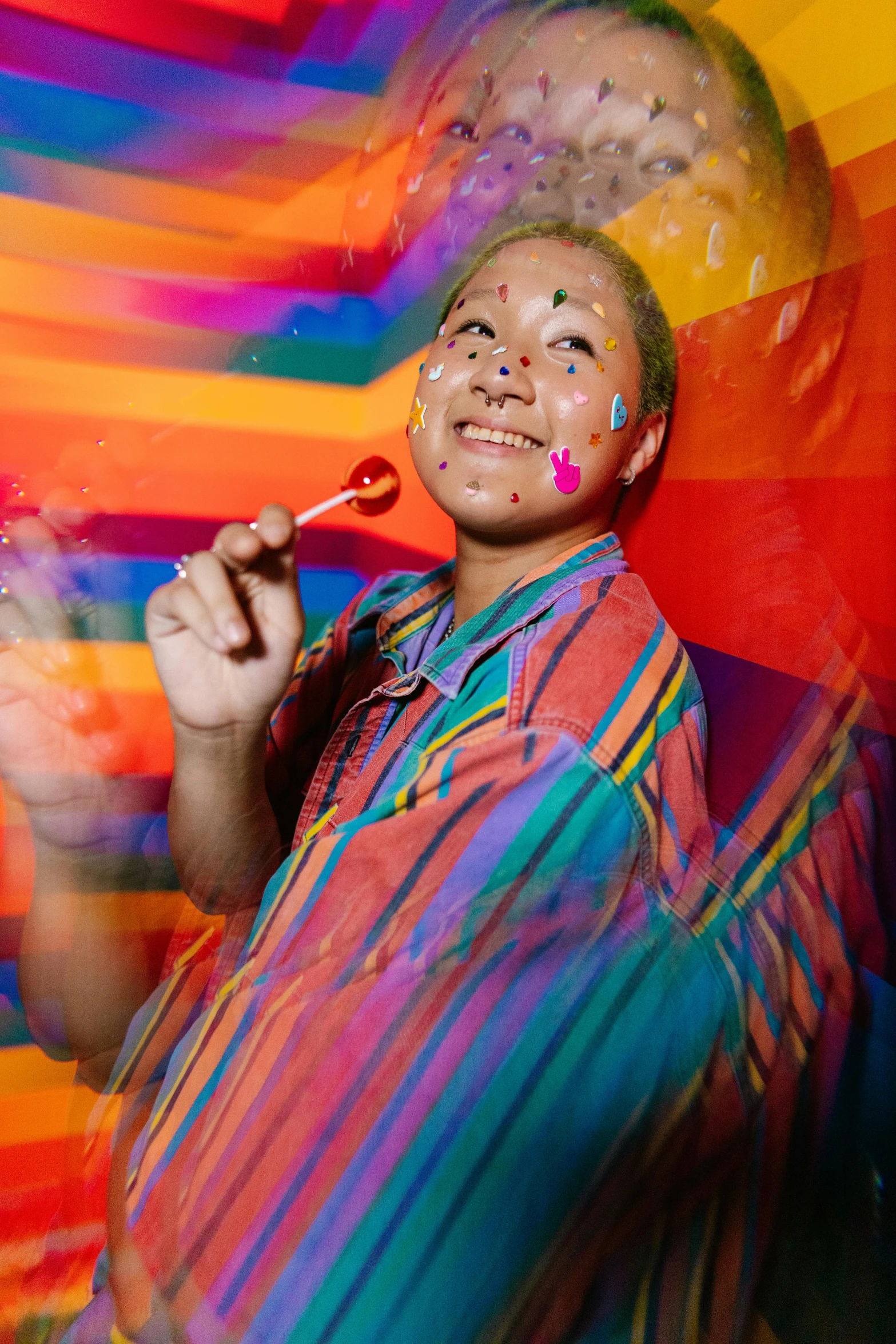 a man that has some paint on his face, an album cover, inspired by Okuda Gensō, pexels contest winner, action painting, holding a paintbrush, made of candy, queer woman, film still promotional image