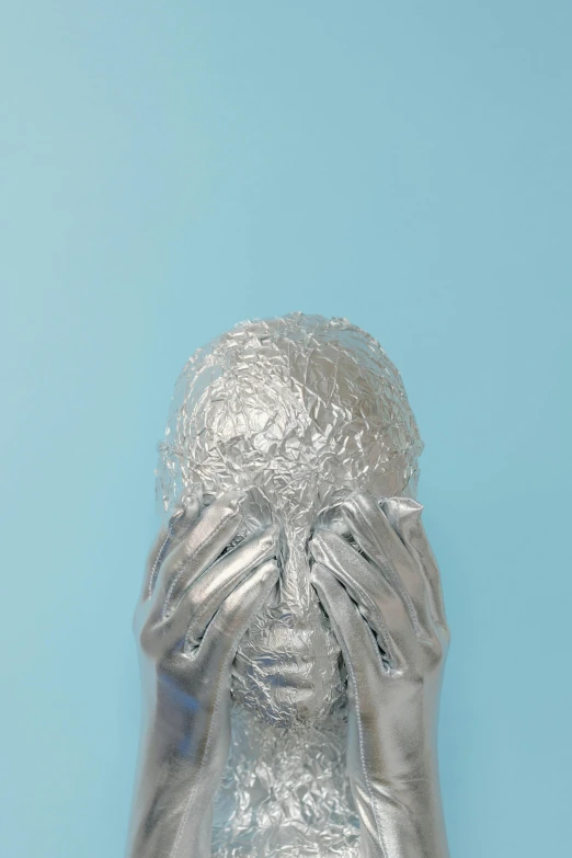 a silver statue of a woman covering her face, an album cover, frustrated detailed, soft vinyl, ignant, head and shoulders view