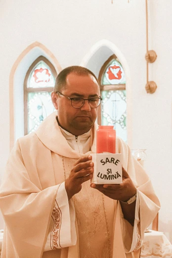 a priest holding a candle in a church, an album cover, by Bernie D’Andrea, unsplash, awkwardly holding red solo cup, wearing white robes, gif, gawr gura