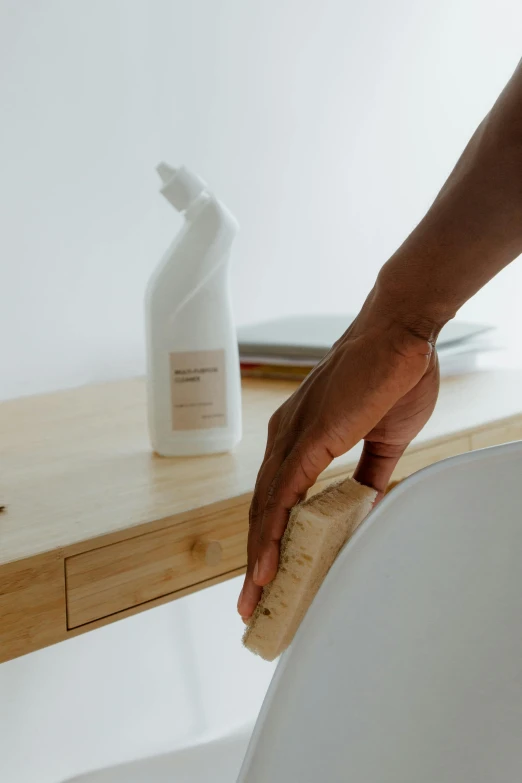 a person cleaning a wooden table with a sponge, unsplash, renaissance, made of bamboo, white finish, dwell, desk