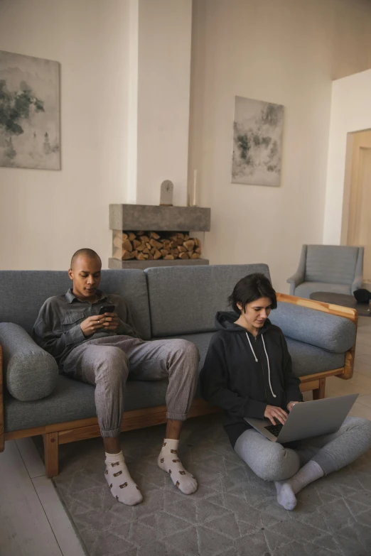 two people sitting on a couch in a living room, pexels, renaissance, coding, wearing a hoodie and sweatpants, hammershøi, beautiful surroundings