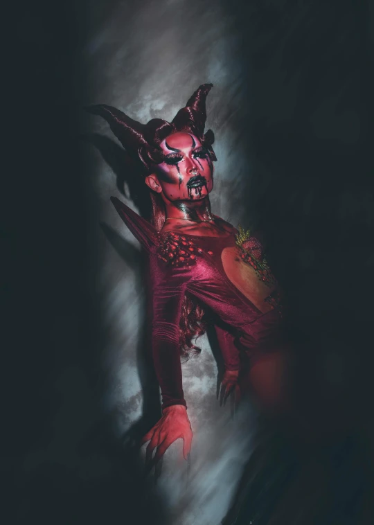 an image of a demon in the dark, an album cover, featured on zbrush central, transgressive art, spraypainted bodypaint graffiti, scarlet witch costume, taken in the early 2020s, horned