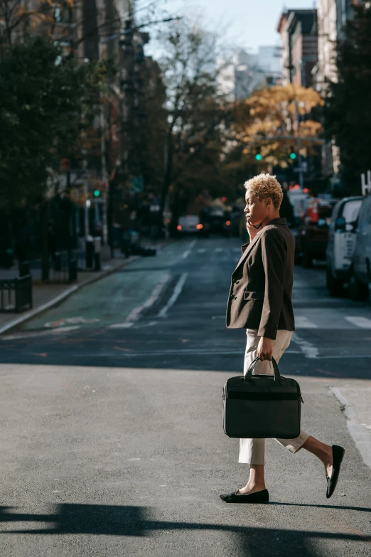 a woman crossing the street with a suitcase, by Nina Hamnett, trending on unsplash, happening, short platinum hair tomboy, in a business suit, brooklyn, ignant