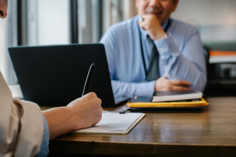 two men sitting at a table working on laptops, a cartoon, unsplash, royal commission, writing on a clipboard, professional closeup photo, background image