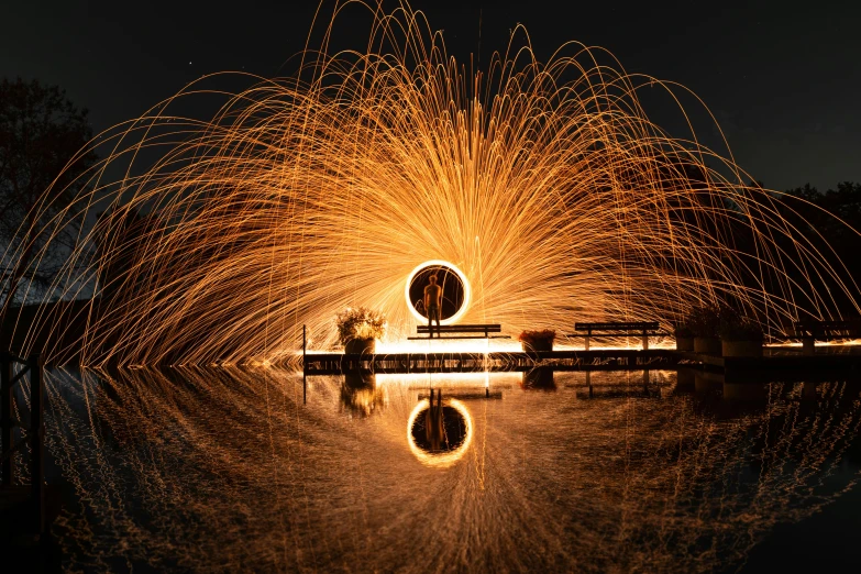 a fire spinning in the air over a body of water, a stipple, by Sebastian Spreng, pexels contest winner, intricate lights, portal to another world, by greg rutkowski, large electrical gold sparks