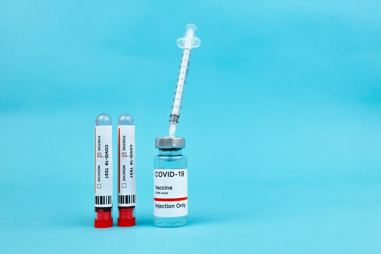 a syll and a vaccine on a blue background, a picture, shutterstock, plasticien, colour corrected, bottles, information, ground - level medium shot