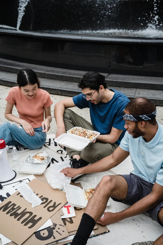 a group of people sitting on the ground eating pizza, pexels contest winner, renaissance, pizza box, hidden message, asian descent, public art