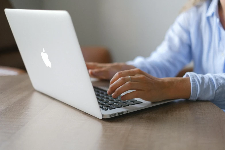 a close up of a person typing on a laptop, by Carey Morris, pexels, with apple, realistic depth, sara ali, all around