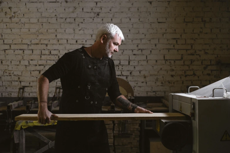 a man working on a piece of wood, a portrait, pexels contest winner, arbeitsrat für kunst, avatar image, full body image, profile image, lovercraft