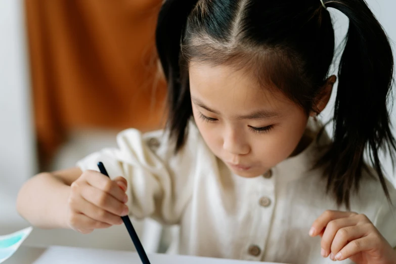 a little girl that is sitting at a table, a child's drawing, pexels contest winner, asian descent, holding pencil, illustration black outlining, bending down slightly