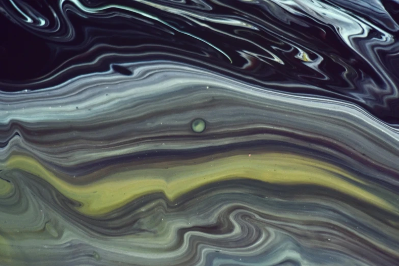 a close up of a liquid painting on a surface, a picture, inspired by Jan Rustem, lyrical abstraction, orbiting a gas giant planet, dark green glass, swirly lunar ripples, vhs colour photography