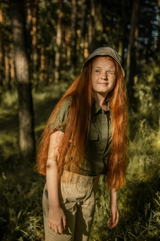 a woman with long red hair standing in a forest, by Grytė Pintukaitė, pexels contest winner, greta thunberg smiling, young female ww 2 soldier, red haired teen boy, summer evening