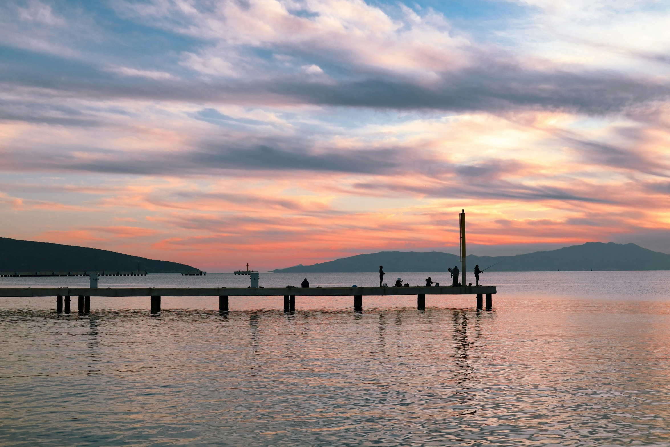 a pier in the middle of a body of water, inspired by Edwin Georgi, pexels contest winner, romanticism, turkey, sunset panorama, wellington, family friendly